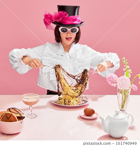 Extraordinary taste. Emotional woman in suglasses and cylinder har eating spaghetti with chocolate sauce over pink background. Dinner time Extraordinary taste. Emotional woman in suglasses and cylinder har eating spaghetti with chocolate sauce over pink background. Dinner time 101740949