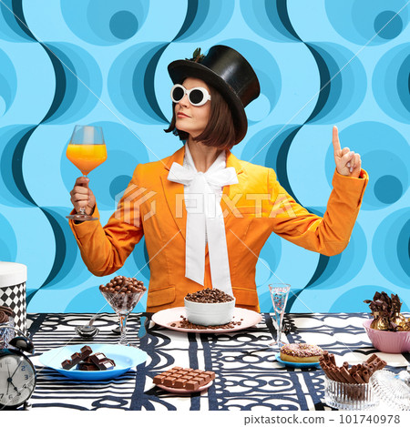 Chocolate lover. Stylish young woman in top hat, sunglasss and orange jaket drinking juice and eating chocolate sweets 101740978