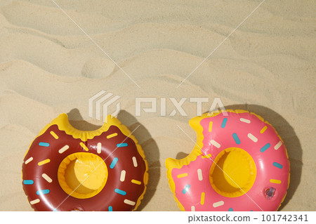 Rubber rings on sand background, space for text Rubber rings on sand background, space for text 101742341