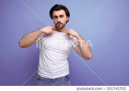 confident young brunette guy in a white t-shirt and jeans confident young brunette guy in a white t-shirt and jeans 101742702