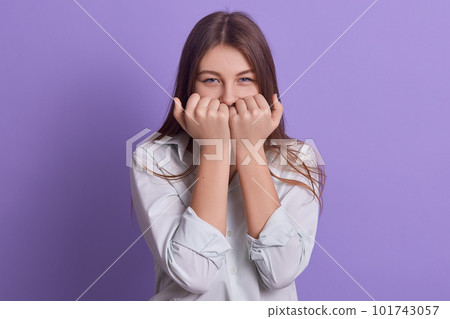Indoor portrait of happy cute energetic young executive covering her face with hands, being in office, working hard, having long hair, looking directly at camera. People and working day concept. Indoor portrait of happy cute energetic young executive covering her face with hands, being in office, working hard, having long hair, looking directly at camera. People and working day concept. 101743057