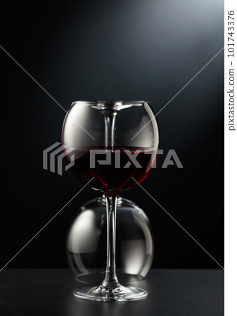Glasses of red wine on a black background. 101743376