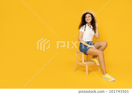 Young woman in casual summer wearing on yellow background Young woman in casual summer wearing on yellow background 101743501