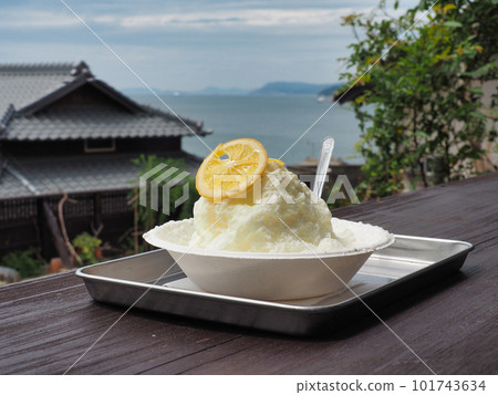 Tasty shaved ice topped with lemon against the backdrop of the ocean on a remote island Tasty shaved ice topped with lemon against the backdrop of the ocean on a remote island 101743634
