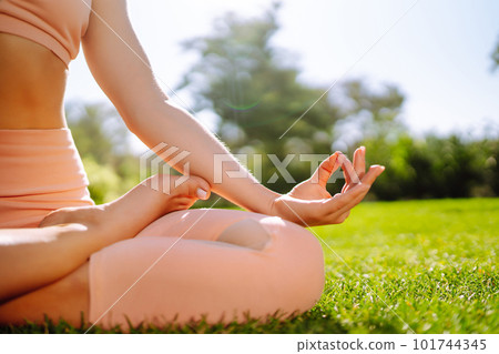 Young woman doing excercise at the public park. Fitness woman doing yoga exercises in the morning. Young woman doing excercise at the public park. Fitness woman doing yoga exercises in the morning. 101744345