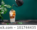 Delicious iced coffee in a glass on green background 101744435