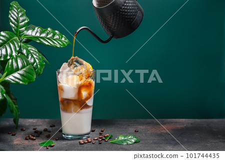 Delicious iced coffee in a glass on green background 101744435