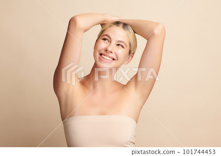 Beautiful Young woman lifting hands up to show off clean and hygienic armpits or underarms on beige background, Smooth armpit cleanliness and protection concept. Beautiful Young woman lifting hands up to show off clean and hygienic armpits or underarms on beige background, Smooth armpit cleanliness and protection concept. 101744453