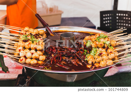Food vendor pork meatballs in skewer with sweet chili sauce in a tray. Food vendor pork meatballs in skewer with sweet chili sauce in a tray. 101744809