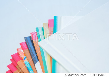 multi-colored spines of photo books close-up, partial blur multi-colored spines of photo books close-up, partial blur 101745869