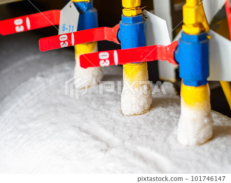 Close-up photo of valves and taps of gas equipment in snow and frost. Close-up photo of valves and taps of gas equipment in snow and frost. 101746147