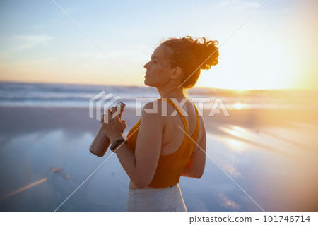 fit woman jogger in sport clothes drinking water 101746714