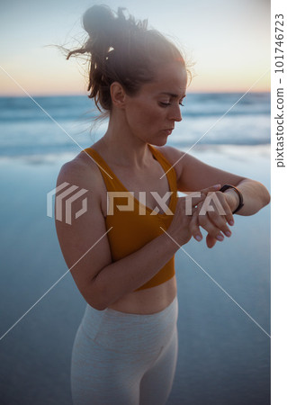 fit sports woman in sport clothes at beach in evening fit sports woman in sport clothes at beach in evening 101746723