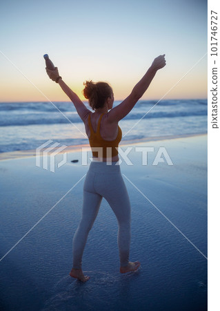 fit sports woman rejoicing at beach at sundown fit sports woman rejoicing at beach at sundown 101746727