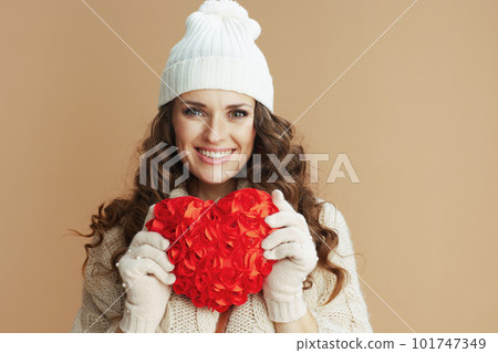 happy trendy woman in beige sweater, mittens and hat happy trendy woman in beige sweater, mittens and hat 101747349