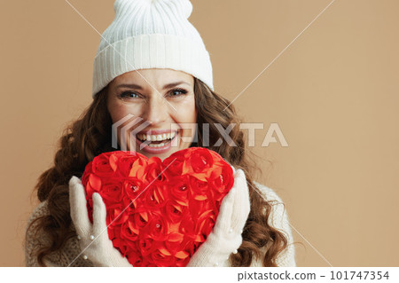 happy trendy female in beige sweater, mittens and hat happy trendy female in beige sweater, mittens and hat 101747354