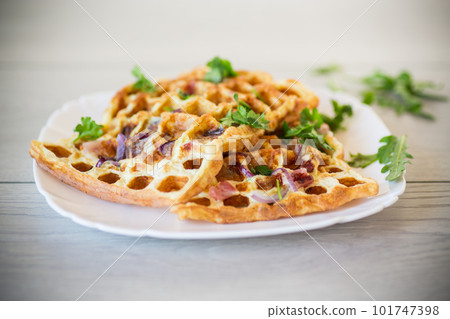 Egg omelette stuffed with onions and herbs, fried in the form of waffles 101747398