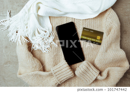 winter flat lay with scarf, smartphone and credit card 101747442