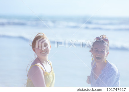 happy stylish mother and child at beach having fun time 101747617
