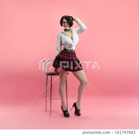 sexy girl with glasses in an erotic schoolgirl costume from a sex shop and white stockings on pink background copy paste sexy girl with glasses in an erotic schoolgirl costume from a sex shop and white stockings on pink background copy paste 101747681