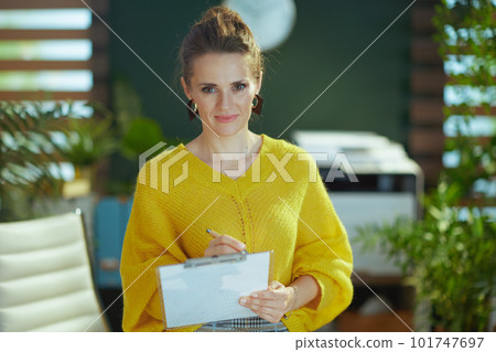 elegant business owner woman in sweater in green office elegant business owner woman in sweater in green office 101747697