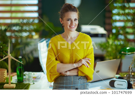 happy trendy business owner woman standing in green office 101747699