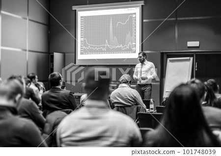 Public Speaker Giving a Talk at Business Meeting. Audience in the conference hall. Business and Entrepreneurship concept. Black and white image. Public Speaker Giving a Talk at Business Meeting. Audience in the conference hall. Business and Entrepreneurship concept. Black and white image. 101748039