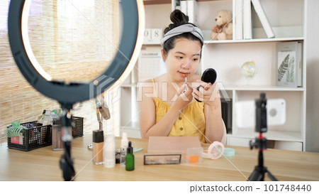 Beautiful women with social media influences are teaching makeup and use cosmetics, In front of the camera to recording vlog video live streaming, Online business on concept of beauty bloggers. 101748440
