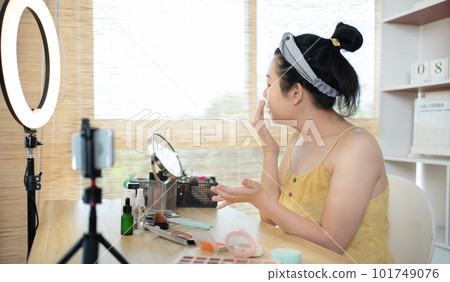 Beautiful women with social media influences are teaching makeup and use cosmetics, In front of the camera to recording vlog video live streaming, Online business on concept of beauty bloggers. Beautiful women with social media influences are teaching makeup and use cosmetics, In front of the camera to recording vlog video live streaming, Online business on concept of beauty bloggers. 101749076
