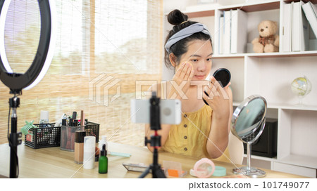 Beautiful women with social media influences are teaching makeup and use cosmetics, In front of the camera to recording vlog video live streaming, Online business on concept of beauty bloggers. Beautiful women with social media influences are teaching makeup and use cosmetics, In front of the camera to recording vlog video live streaming, Online business on concept of beauty bloggers. 101749077