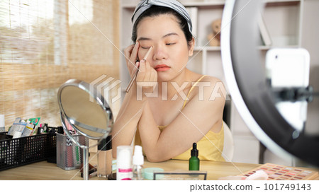 Beautiful women with social media influences are teaching makeup and use cosmetics, In front of the camera to recording vlog video live streaming, Online business on concept of beauty bloggers. Beautiful women with social media influences are teaching makeup and use cosmetics, In front of the camera to recording vlog video live streaming, Online business on concept of beauty bloggers. 101749143