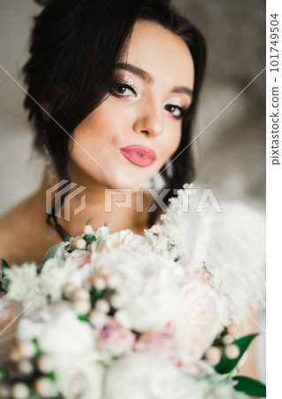Portrait of stunning bride with long hair posing with great bouquet Portrait of stunning bride with long hair posing with great bouquet 101749504
