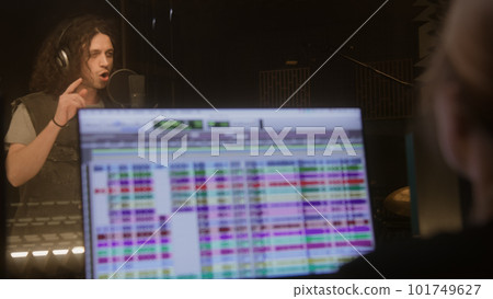 Professional singer in headphones sings composition Professional singer in headphones sings composition 101749627