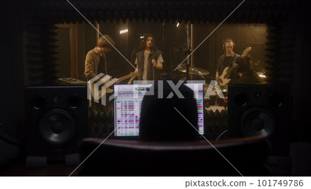 Musical band records song in music recording room Musical band records song in music recording room 101749786