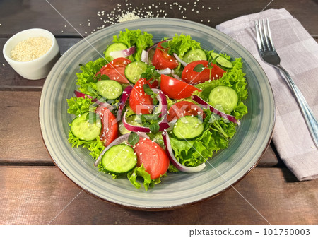 Salad of fresh tomatoes and cucumbers in a bowl Salad of fresh tomatoes and cucumbers in a bowl 101750003
