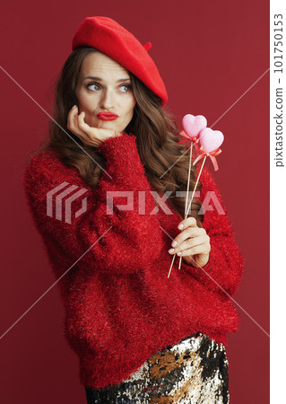 pensive trendy woman with long wavy hair and hearts on stick pensive trendy woman with long wavy hair and hearts on stick 101750153