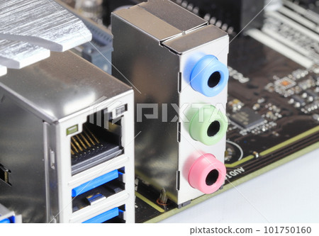Multiple ports on modern computer mainboard show with USB 3.1, LAN, audio ports. 101750160