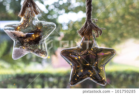 Christmas toys in the shape of a star isolated on the window and greenery 101750285