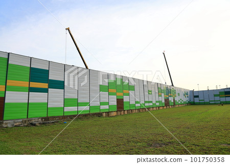 Covered facade of a reconstruction building or construction site, with picture print of art. Covered facade of a reconstruction building or construction site, with picture print of art. 101750358