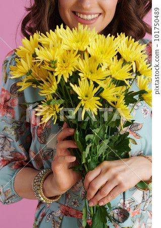 Smiling woman with long wavy brunette hair on pink 101750489