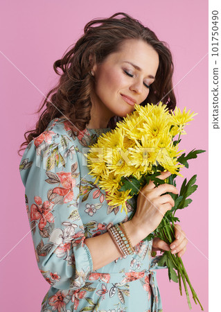 relaxed modern woman in floral dress on pink relaxed modern woman in floral dress on pink 101750490