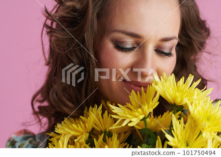 smiling modern female with long wavy brunette hair on pink 101750494