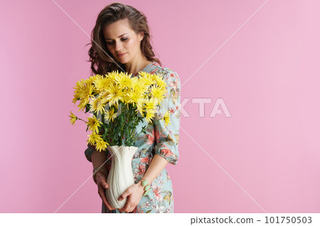trendy woman in floral dress on pink 101750503