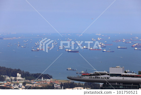 Aerial view of ocean liner and Cargo Ship in Singapore Strait as a background of Marina Bay Sands Singapore building. 101750521