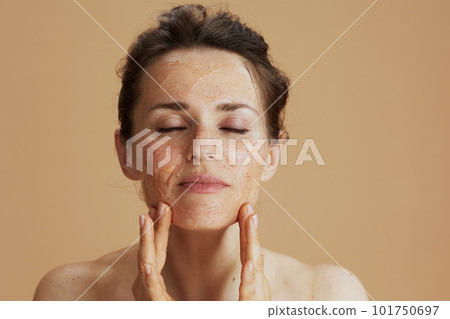modern woman with face scrub isolated on beige 101750697