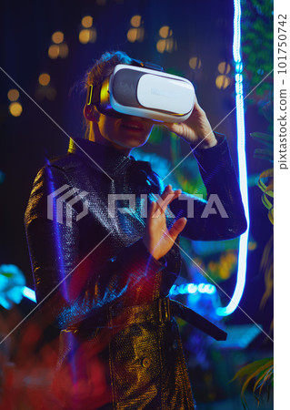 stylish female in metaverse in vr goggles exploring stylish female in metaverse in vr goggles exploring 101750742