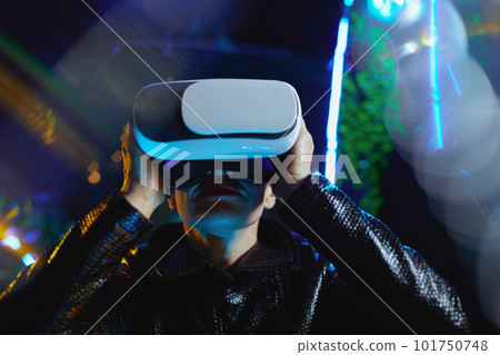 modern 40 years old woman in metaverse in vr goggles 101750748