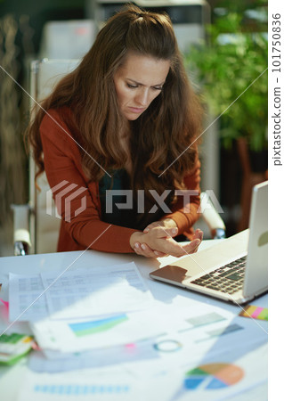 stylish small business owner woman in modern green office 101750836