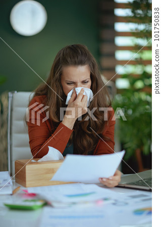 business owner woman blowing nose and working with documents 101750838