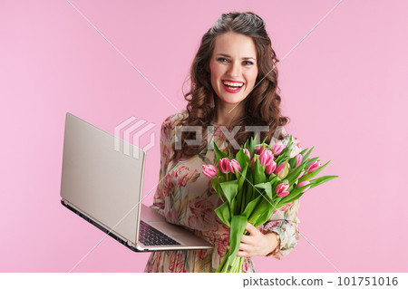 smiling modern woman in floral dress on pink 101751016